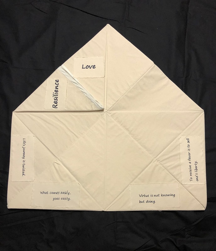 Flat origami fabric piece with philosophical text — collaboration artwork