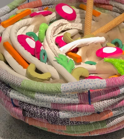 Play With Your Food — close-up of colorful fabric noodles and vegetables in bowl sculpture