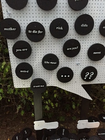 PRE_TEXTING — black word discs on pegboard speech bubble