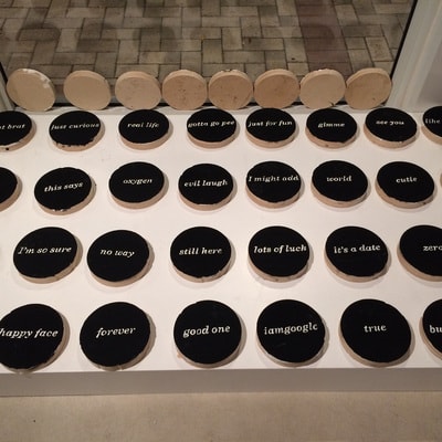 PRE_TEXTING — flat black word discs arranged in gallery