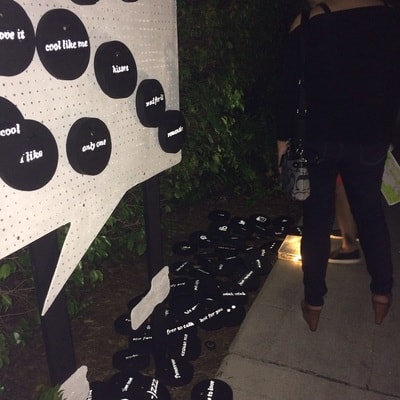 PRE_TEXTING installation — discs spilling outside at night
