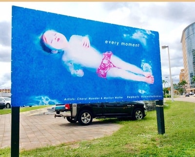 Celestial Babies billboard — 'every moment' — Artists Cheryl Maeder & Marilyn Walter, West Palm Beach
