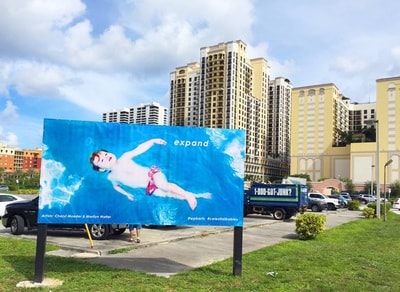 Celestial Babies billboard — 'expand' — public art installation, West Palm Beach