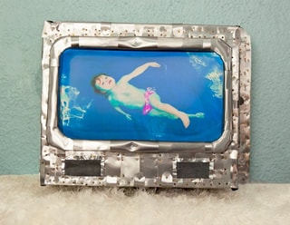 Celestial Babies framed sculpture — baby floating in blue water, metal frame