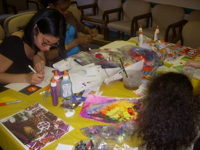 Community participants engaged in collaborative craft activity at table